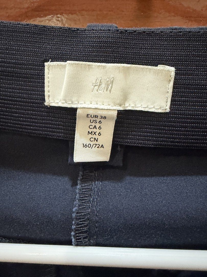 H&M Navy Blue Trousers Size US 6 (Category: Jeans) located in Manila. Submitted by carat.md (Listing ID 1464780813, Image 2). Description: - Brand: H&M - Color: Navy Blue - Size: EUR 38 / US 6 / CA 6 / MX 6 / CN 160/72A - Waist: Elastic at the back with belt loops for comfort and fit - Closure: Standard zip fly and button - Pockets: Functional front pockets - Condition: Clean fabric, solid dark color - Style: Versatile for everyday office or casu