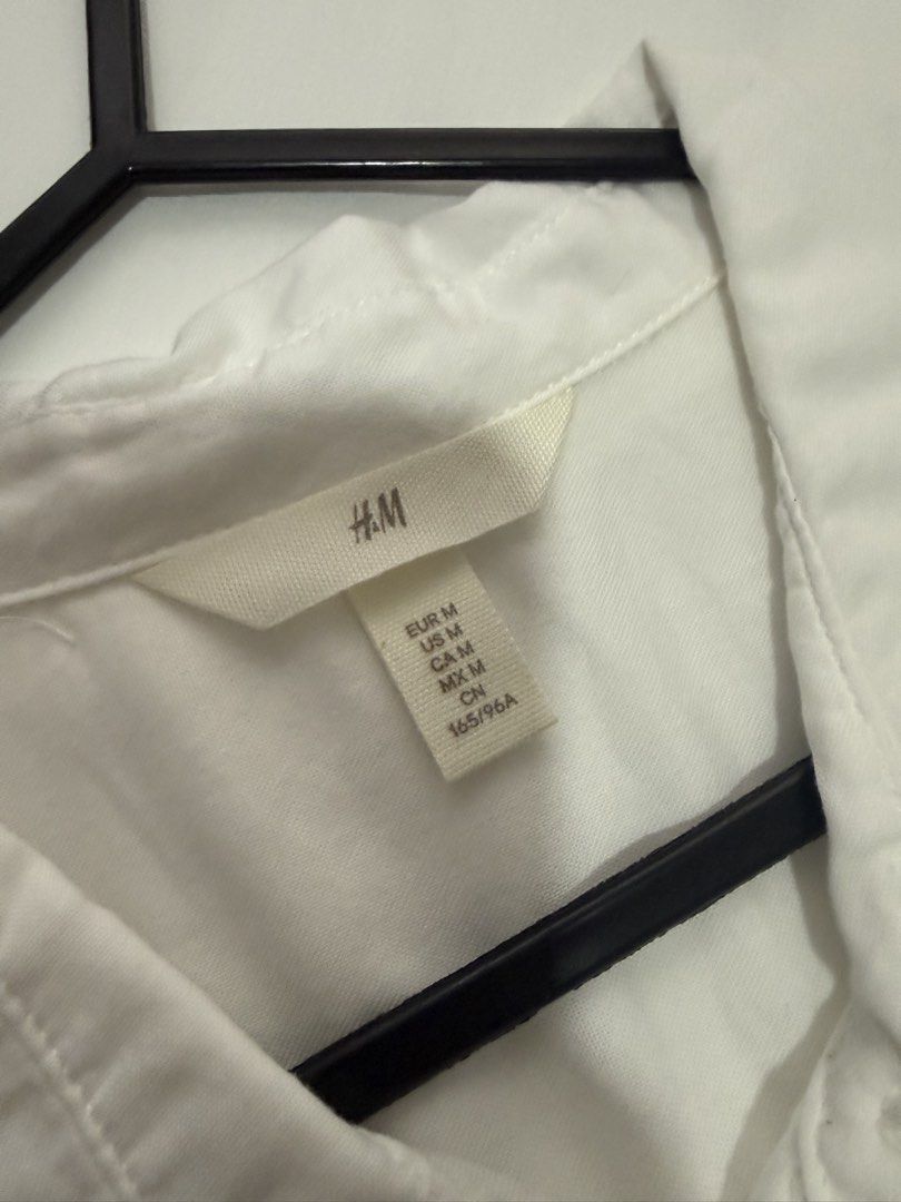 H&M White Button-Up Long Sleeve Shirt (Category: Longsleeves) located in Quezon City. Submitted by jessyda (Listing ID 1464825072, Image 2). Description: - Brand: H&M - Item: Classic white long-sleeve button-up shirt - Size: Medium - Details: Standard collar, front button placket, single left chest pocket - Fabric: Crisp and lightweight - Condition: Excellent wardrobe basic, ready to wear - Styling: Perfect tucked into trousers or worn open over 