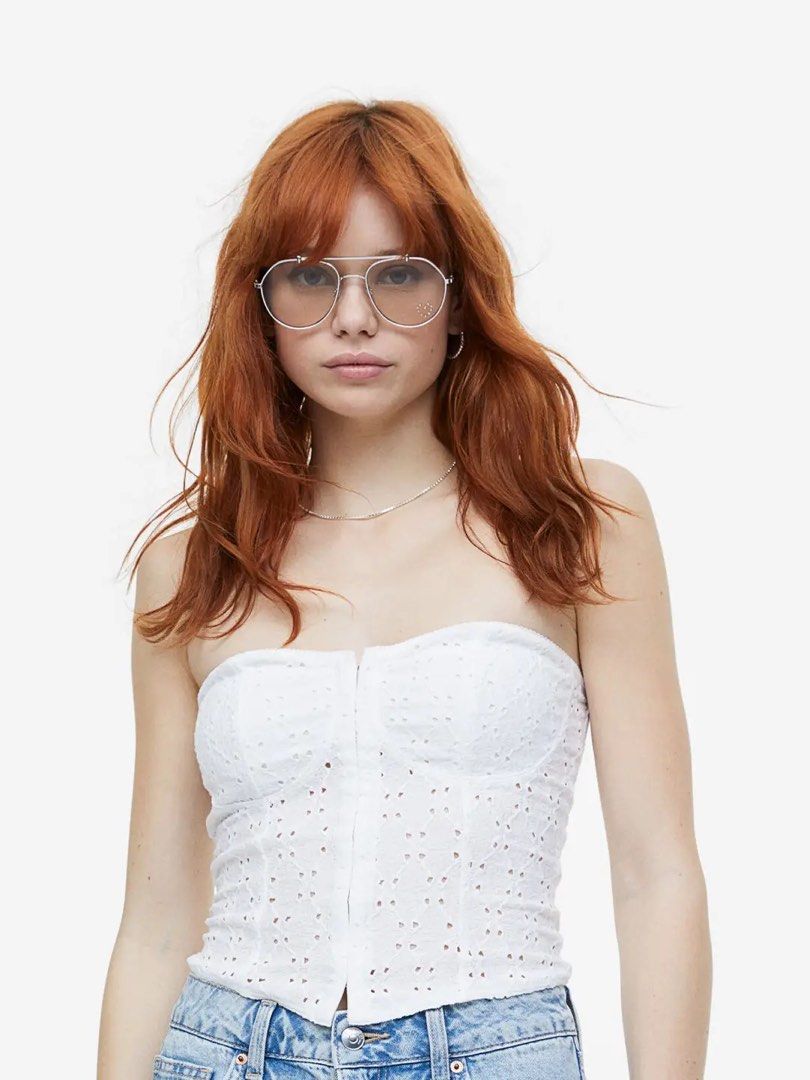H&M White eyelet bustier crop top (Category: Sleeveless) located in Quezon City. Submitted by shop.cassie (Listing ID 1464800942, Image 1). Description: - Color: White - Style: Strapless corset top with delicate eyelet embroidery - Features: Structured bust cups, scalloped trim, and front hook-and-eye closure - Straps: Includes optional thin straps - Material: Comfortable cotton blend - Occasion: Ideal for summer days or night outs - Condition: B