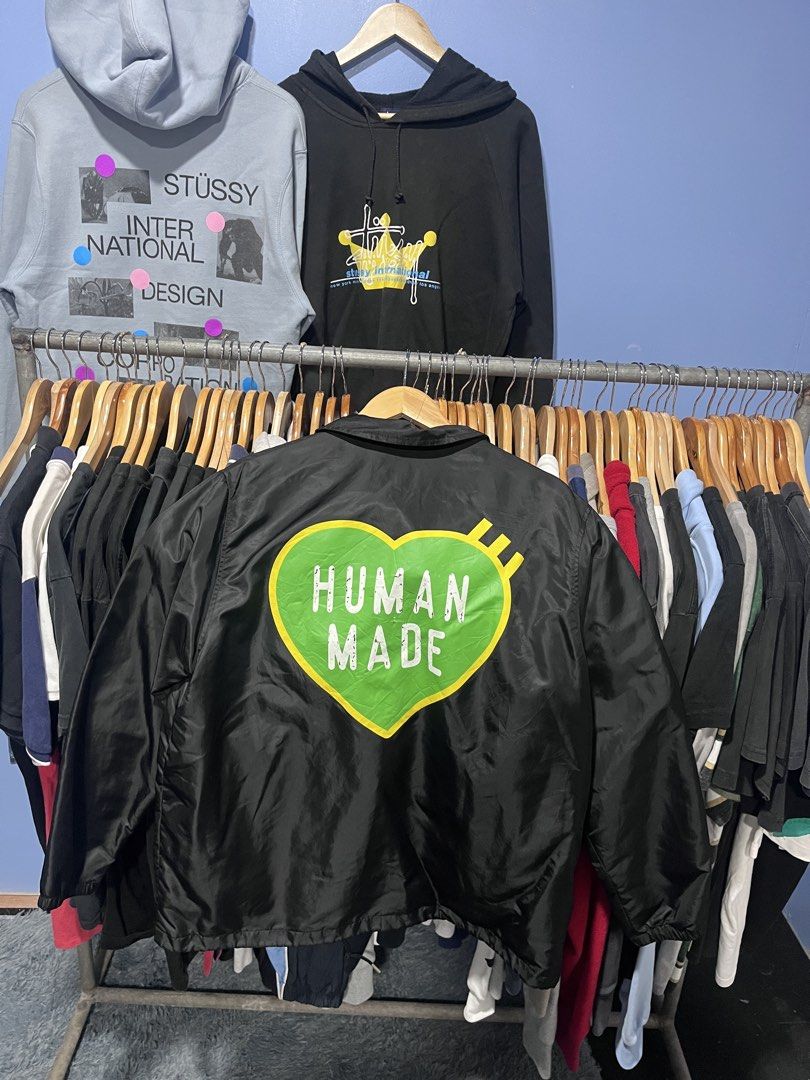 Human Made Black Coach Jacket Size L (Category: Coats, Jackets and Outerwear) located in Davao. Submitted by erwin_james (Listing ID 1464889077, Image 2). Description: - Brand: Human Made (by Nigo) - Style: Black coach jacket with collared neckline and snap button closure - Size: Large - Design: Large green heart graphic with white branding on the back, matching green heart on the left chest - Details: Features inner lining and authentic tag bran