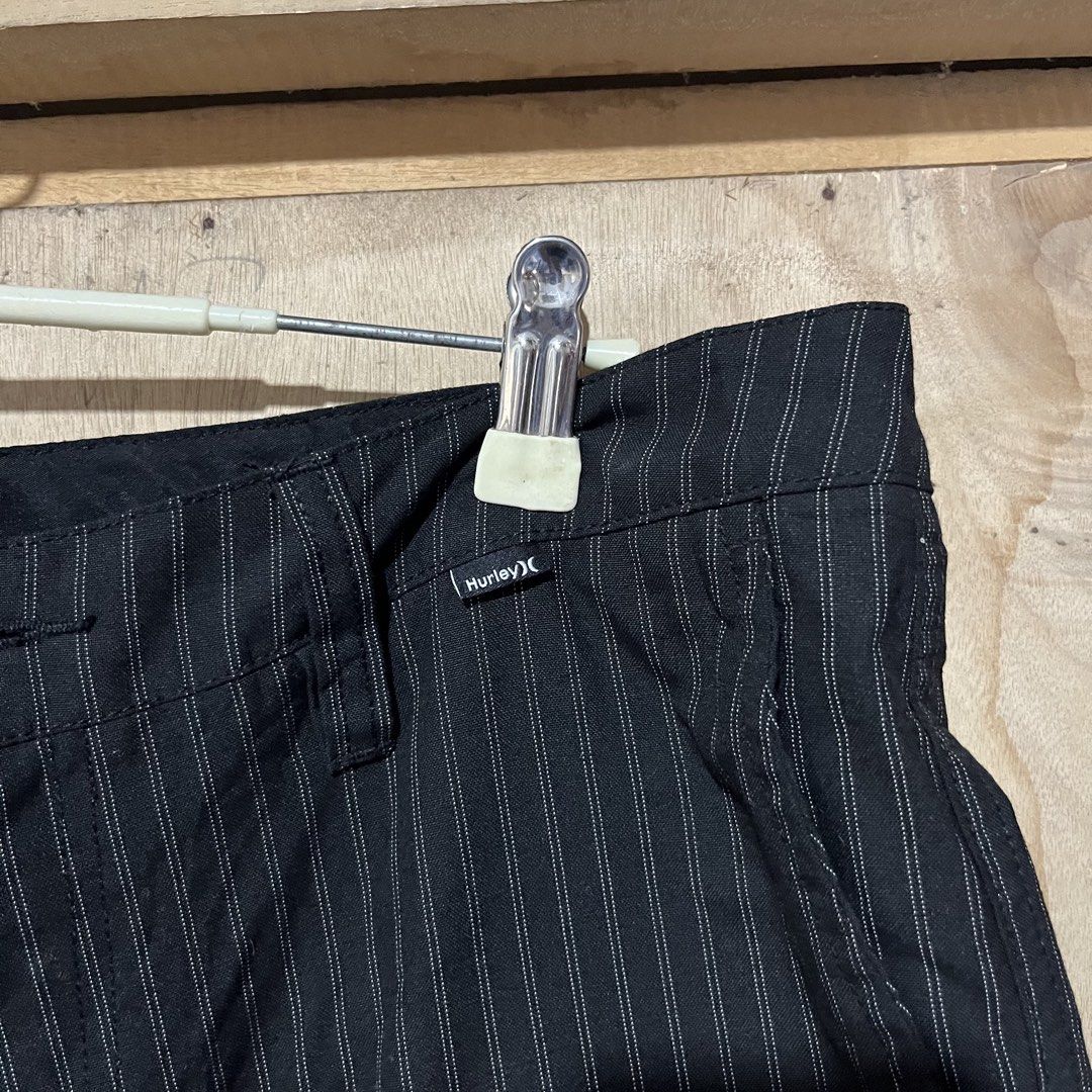 Hurley Black Pinstripe Shorts Size 33 (Category: Shorts) located in Sipalay. Submitted by rjhndarnie19 (Listing ID 1464797520, Image 3). Description: - Brand: Hurley - Color: Black with subtle pinstripes - Size: 33 (Made in India) - Features: Button closure, belt loops, and functional front pockets - Detail: Small embroidered Hurley logo on the lower left leg - Condition: Excellent pre-loved condition, 100% authentic - Perfect for casual outings 