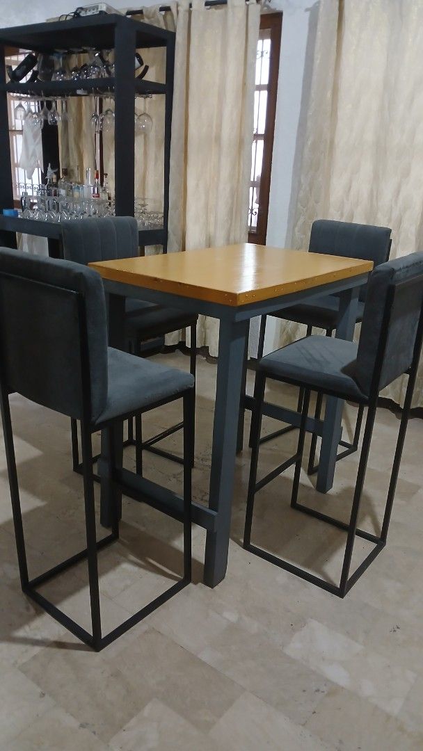 Industrial Bar Table with 4 Chairs (Category: Tables & Sets) located in Angeles City. Submitted by pamdiel003 (Listing ID 1464801844, Image 3). Description: - Style: Industrial bar table set with matching chairs - Inclusions: 1 wooden-top table with sturdy metal frame and 4 upholstered chairs - Chair Details: Dark grey fabric with matching metal legs - Design: Space-saving, ideal for smaller apartments or condo kitchens - Quality: Solid construct