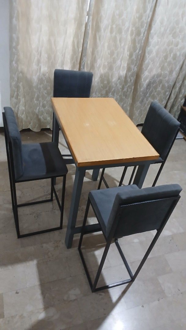 Industrial Bar Table with 4 Chairs (Category: Tables & Sets) located in Angeles City. Submitted by pamdiel003 (Listing ID 1464801844, Image 2). Description: - Style: Industrial bar table set with matching chairs - Inclusions: 1 wooden-top table with sturdy metal frame and 4 upholstered chairs - Chair Details: Dark grey fabric with matching metal legs - Design: Space-saving, ideal for smaller apartments or condo kitchens - Quality: Solid construct