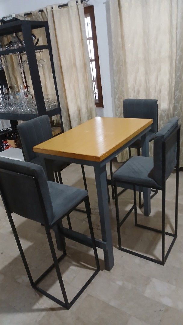 Industrial Bar Table with 4 Chairs (Category: Tables & Sets) located in Angeles City. Submitted by pamdiel003 (Listing ID 1464801844, Image 1). Description: - Style: Industrial bar table set with matching chairs - Inclusions: 1 wooden-top table with sturdy metal frame and 4 upholstered chairs - Chair Details: Dark grey fabric with matching metal legs - Design: Space-saving, ideal for smaller apartments or condo kitchens - Quality: Solid construct