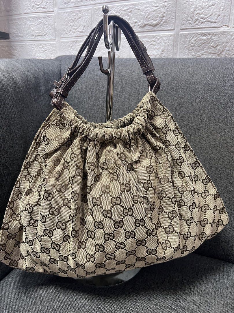 Inspired Gucci Monogram Canvas Drawstring Shoulder Bag (Category: Luxury Bags & Wallets) located in General Trias. Submitted by mybag2025 (Listing ID 1462851201, Image 3). Description: - Gucci shoulder bag coded - Classic GG monogram canvas - Brown leather trim and straps - Drawstring closure - Interior pocket - Shows some signs of wear on leather and canvas.