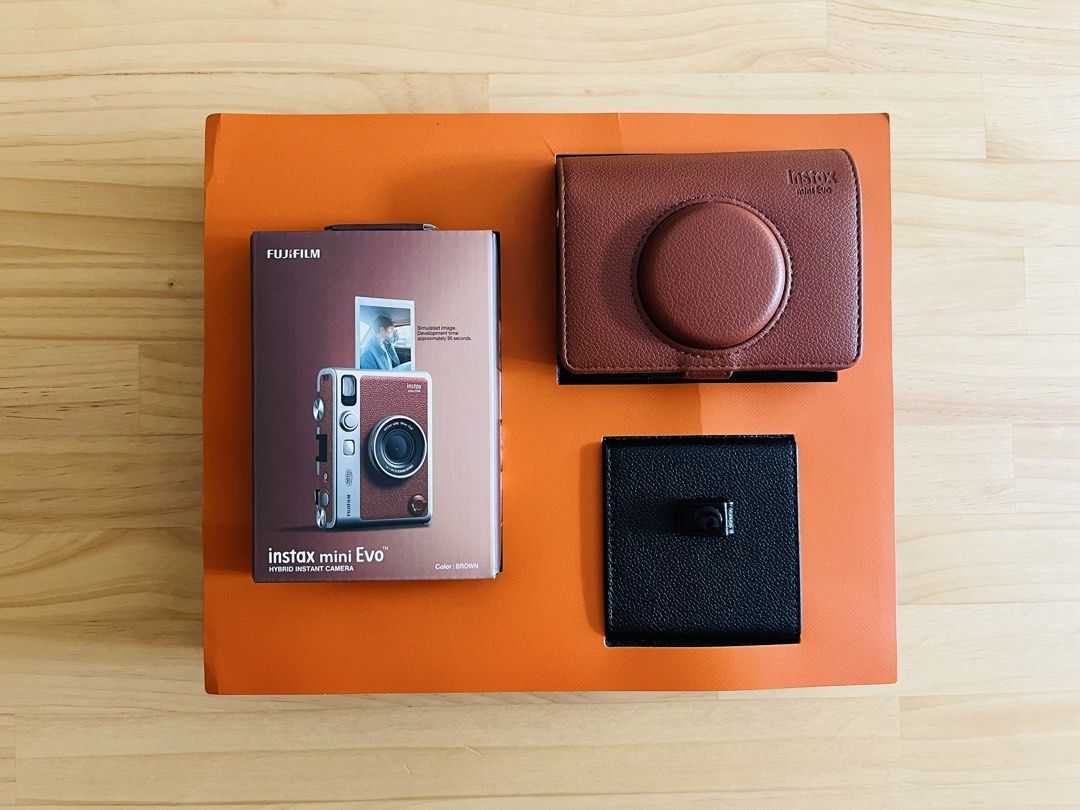 Instax Mini Evo Leather Kit (Brown) (Category: Cameras) located in Manila. Submitted by nucellenagar (Listing ID 1464771490, Image 2). Description: Instax Mini Evo Leather Kit (Brown) - Good as new - No issues and fully functional - Original price: P14,999 Inclusions: • Instax Mini Evo Brown • SD Card (32GB) • Leather case • Photo album • Photo frames Note: No films included. Location: Sikatuna Village, Diliman, QC.