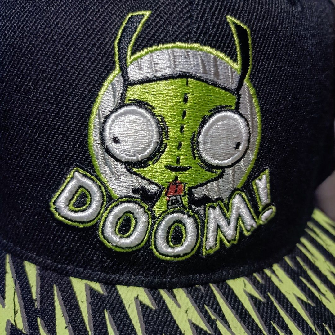 Invader Zim Gir Doom Snapback Hat Nickelodeon (Category: Caps & Hats) located in Manila. Submitted by nye.seller (Listing ID 1464886629, Image 2). Description: - Official Nickelodeon Invader Zim merchandise (2024) - Features embroidered Gir graphic with "DOOM!" on the front - All-over bright green lightning bolt print on the flat brim - Neon green adjustable plastic snap closure and matching top button - Invader Zim logo embroidered above the bac