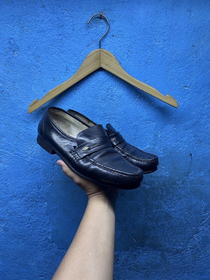 Jarman Black Leather Penny Loafers (Category: Dress Shoes) located in Quezon City. Submitted by thriftxgoods (Listing ID 1464898103, Image 2). Description: Classic black leather penny loafers from Jarman. Slip-on design with strap detail across the vamp. Textured soles for grip. Interior shows wear with branded insoles. Leather uppers show natural creasing from use. Solid everyday dress shoes..