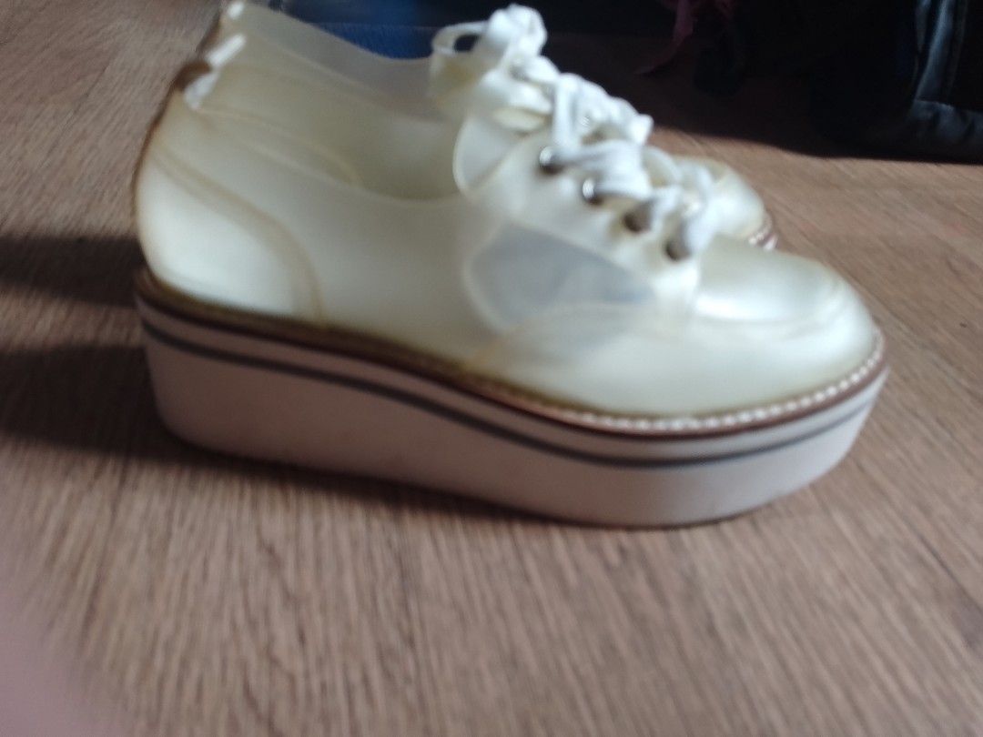 Jessica Simpson Jelly Platform Sneakers (Category: Sneakers) located in Manila. Submitted by jhaynee (Listing ID 1464781413, Image 2). Description: - Brand: Jessica Simpson - Style: Clear jelly platform sneakers - Color: Clear with white laces - Comfort: Cushioned insoles featuring the brand logo - Sole: Chunky platform with horizontal tread for grip - Condition: Normal signs of wear on the soles, overall great shape.