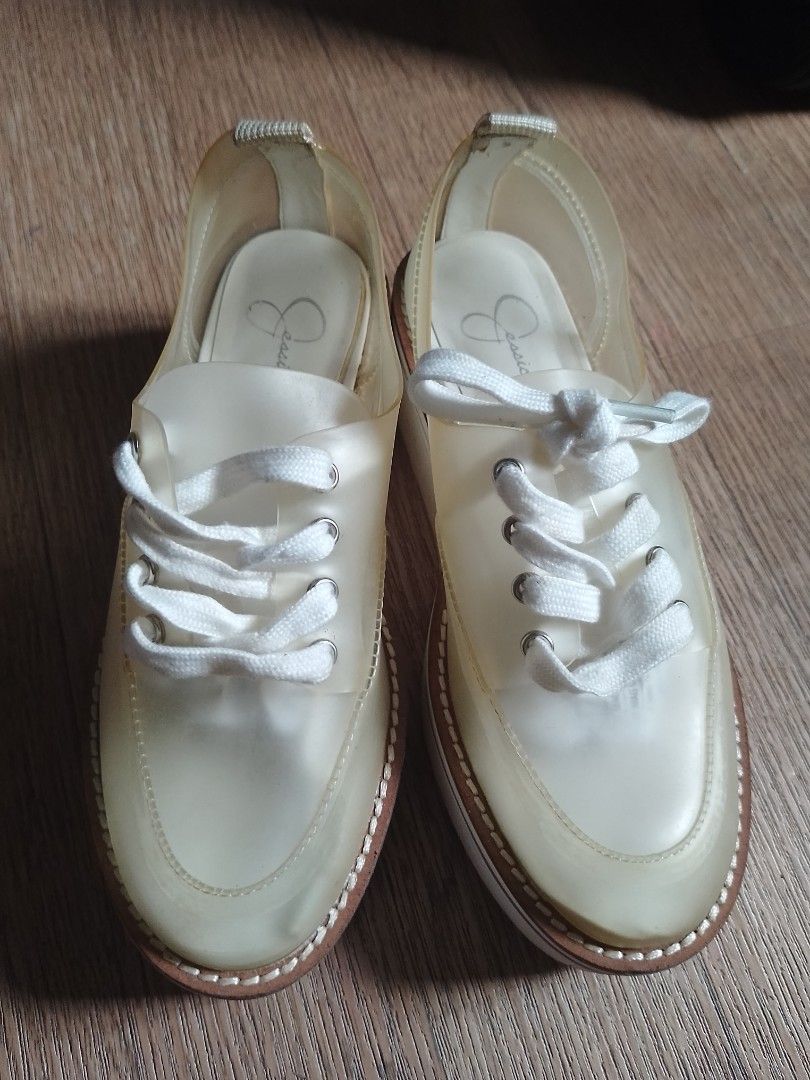 Jessica Simpson Jelly Platform Sneakers (Category: Sneakers) located in Manila. Submitted by jhaynee (Listing ID 1464781413, Image 1). Description: - Brand: Jessica Simpson - Style: Clear jelly platform sneakers - Color: Clear with white laces - Comfort: Cushioned insoles featuring the brand logo - Sole: Chunky platform with horizontal tread for grip - Condition: Normal signs of wear on the soles, overall great shape.