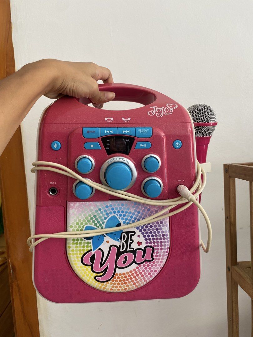 JoJo Siwa Be You Karaoke Machine with Microphone (Category: Kids Toys) located in Santa Rosa. Submitted by hoardqueensdeclutter (Listing ID 1464895808, Image 1). Description: - Official JoJo Siwa karaoke machine in bright pink - Features a large 'Be You' graphic with a fun, colorful dot pattern - Includes one wired microphone (plugged into the side port) - Easy-to-use master volume dial, control knobs, and digital display - Built-in pink top hand