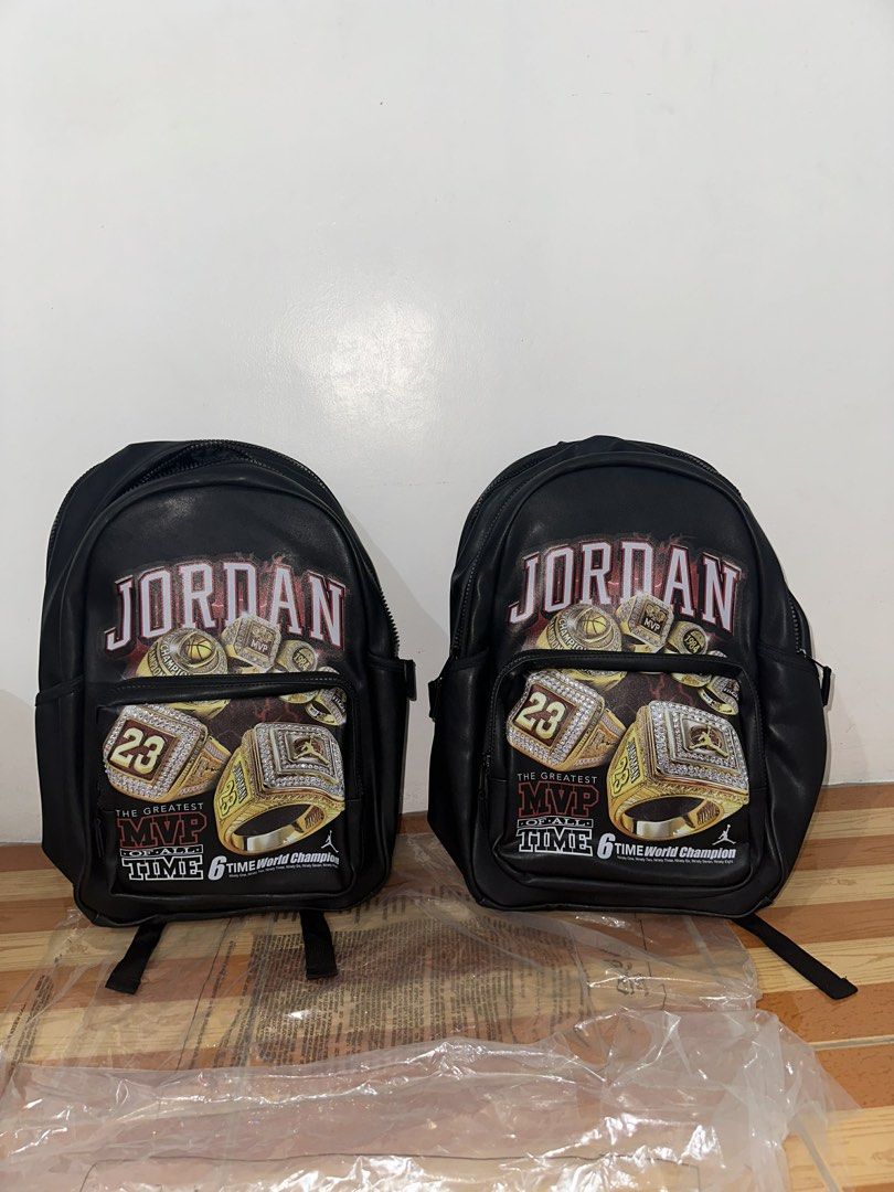 Jordan 6 Time World Champion Backpack Black (Category: Backpacks) located in Caloocan City. Submitted by garo1378 (Listing ID 1464839704, Image 2). Description: - 100% Authentic Jordan backpack in sleek black - Eye-catching championship rings graphic with bold red lettering on front pocket - 2 spacious main zippered compartments for organized storage - Convenient side bottle pockets - Comfortable adjustable shoulder straps featuring the iconic Ju