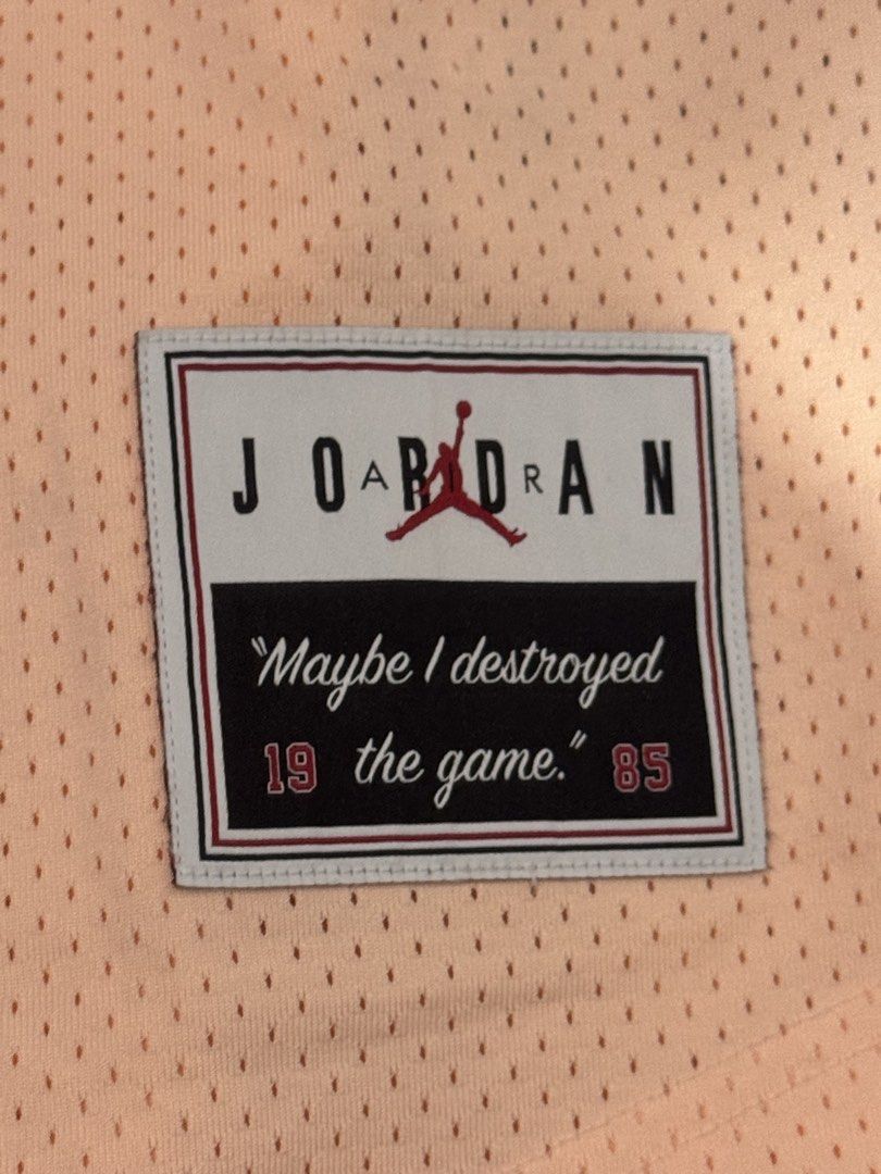 Jordan Jersey 100% Original (Category: Luxury Apparel) located in Manila. Submitted by wildbear.e10374 (Listing ID 1464809344, Image 3). Description: - Brand: Jordan - Color: Peach - Material: Breathable athletic mesh - Front Details: Number '23' on front Lettering Embroidery - Back Details: Arched 'JORDAN' Embroidery across upper shoulders - Special Features: Lower hem patch with 'Maybe I destroyed the game' quote and '1985' years - Accents: Sma