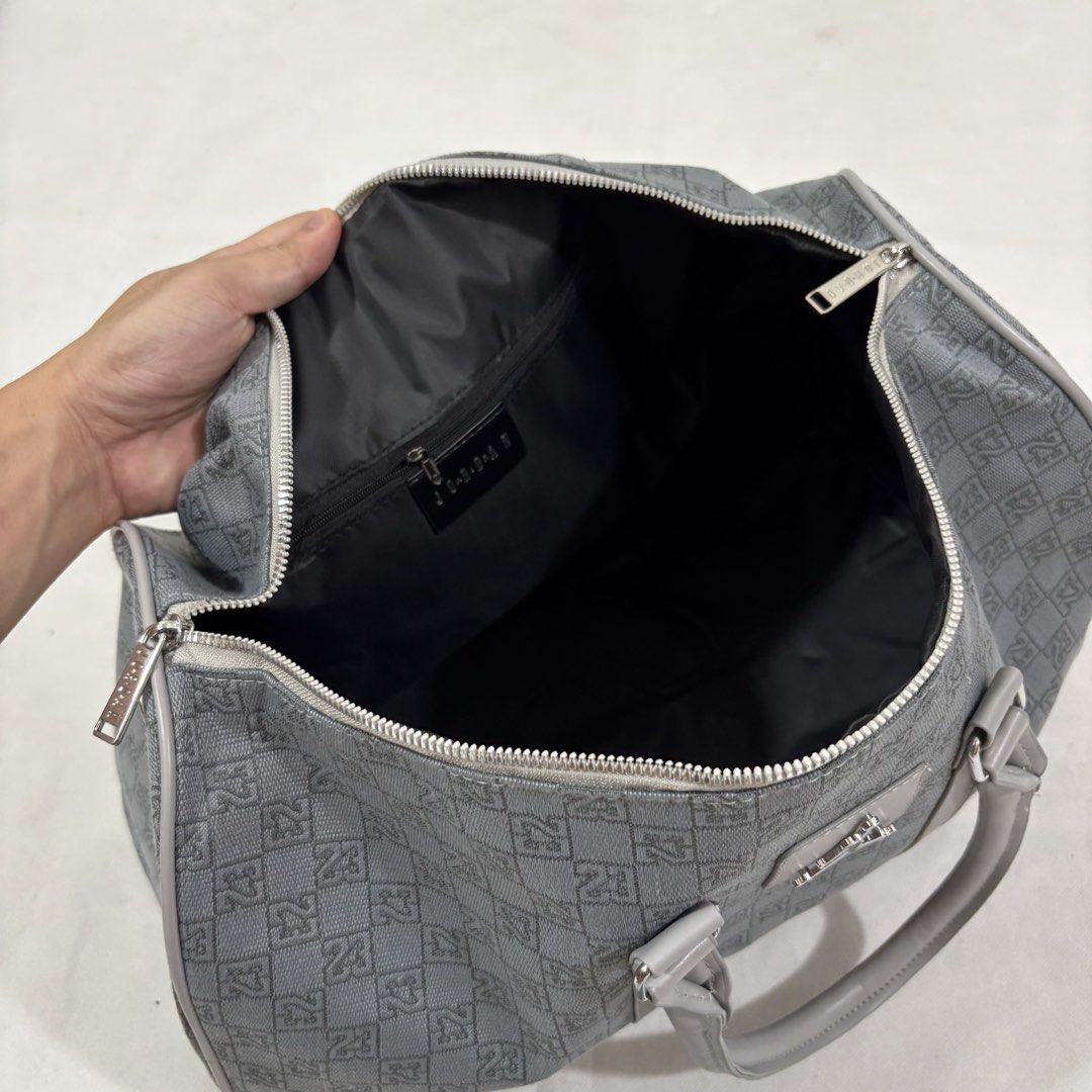 Jordan Monogram Pattern Duffel Bag Grey Y2k (Category: Luxury Bags & Wallets) located in Cavite. Submitted by itsayaaa (Listing ID 1464837962, Image 3). Description: - Jordan duffel bag in a stylish grey monogram pattern - Silver-tone hardware with iconic Jumpman logo on the front and strap - Secure top zip closure with sturdy dual carrying handles - Includes an adjustable and detachable shoulder strap for versatile wear - Spacious dark-lined int