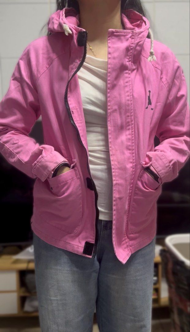 Nike Jordan Hooded Utility Jacket - Pink (Category: Coats, Jackets and Outerwear) located in Surigao. Submitted by boonz71_1971 (Listing ID 1464923937, Image 1). Description: “Declutter Sale - Gently used” - Brand: Jordan - Color: Bright Pink with Black details - Size: Small Width: 18” Length 22” - Design: Black Jumpman logo, big JORDAN lettering, and number 23 on chest and back - Features: Full zip front, adjustable hood drawstrings, multiple po
