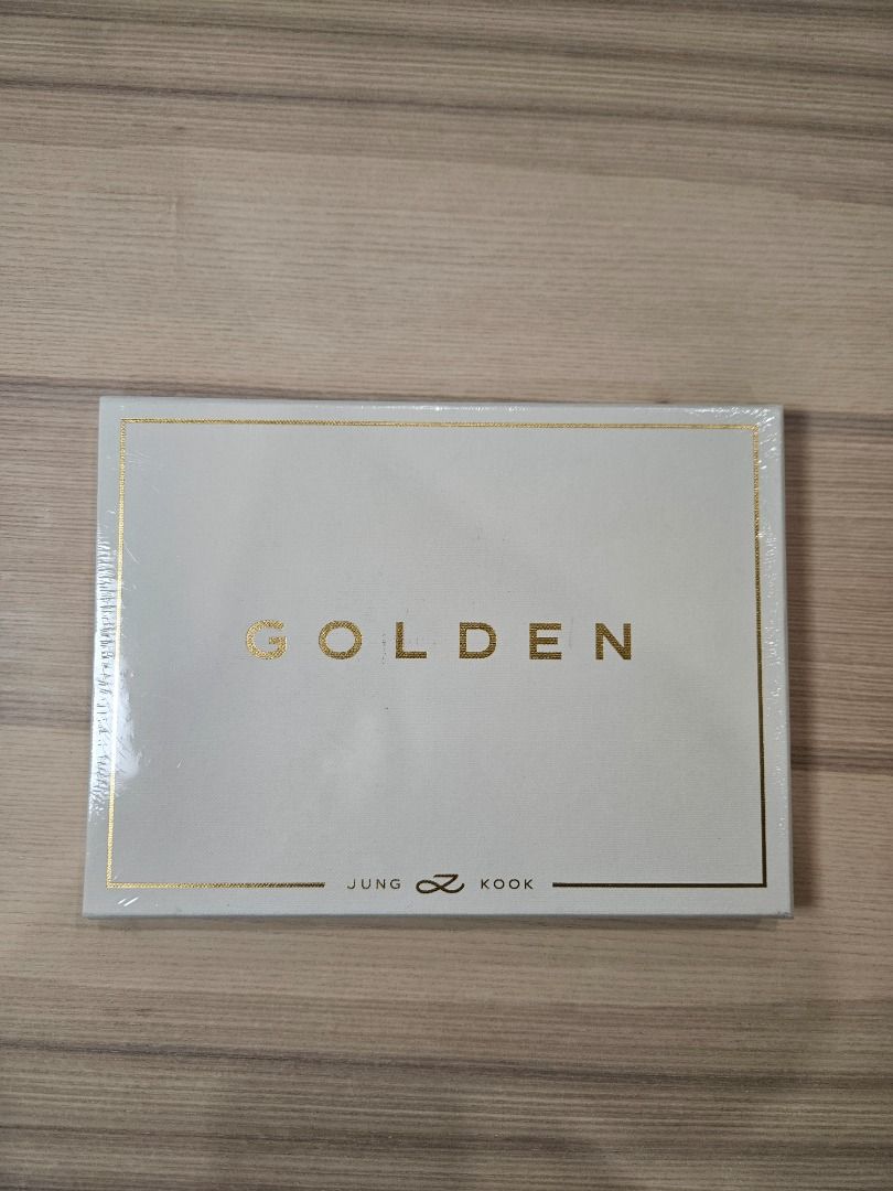 BTS Jung Kook GOLDEN Solid Version Album (Category: CDs & DVDs) located in Quezon City. Submitted by hey_rita (Listing ID 1464849116, Image 1). Description: - Official BIGHIT MUSIC release: Jung Kook 'GOLDEN' Album (Solid Version) - Condition: Brand new, sealed in original plastic wrap - Authenticity: Comes with official KOMCA sticker on the back - Design: White textured cover with elegant gold foil lettering - Inclusions: 1 CD, 1 Photobook, 2 Po