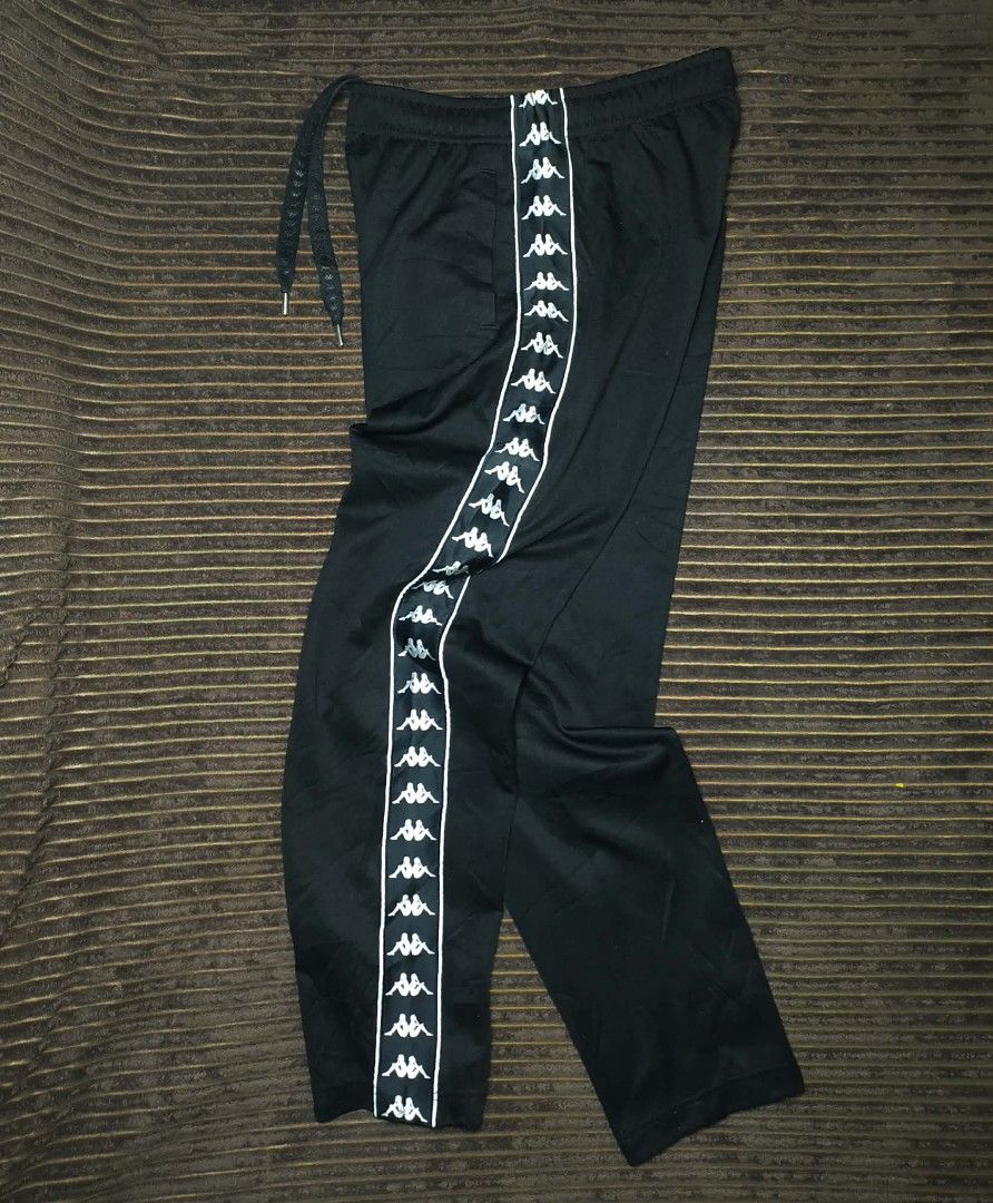 Kappa Black Track Pants with Side Tape Logo Size Medium (Category: Joggers) located in Manila. Submitted by norathrifted (Listing ID 1464799224, Image 1). Description: - Authentic Kappa track pants in classic black - Size: Medium (with red brand tag) - Iconic Omni logo taped down both legs - Elastic waistband with adjustable drawstring and metal tips - Deep and convenient side pockets - Soft, premium fabric ideal for lounging or workouts.
