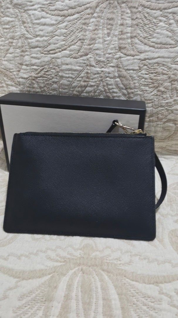 Kate Spade Black Leather Wristlet Wallet (Category: Wallets & Card holders) located in Makati City. Submitted by edgeeh (Listing ID 1464914276, Image 2). Description: - Authentic Kate Spade New York wristlet - Crafted from durable black Saffiano leather with sleek gold hardware - Features a convenient front zip pocket and detachable wrist strap - Secure top-zip main compartment with a clean interior lining - Compact and practical everyday accesso