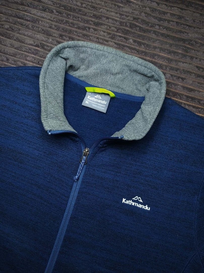 Kathmandu Blue Fleece Jacket XL (Category: Coats, Jackets and Outerwear) located in Manila. Submitted by norathrifted (Listing ID 1464801619, Image 2). Description: - Brand: Kathmandu - Style: Full-zip fleece jacket - Color: Deep blue with grey ribbed inner collar - Logo: White embroidered on chest - Pockets: Two secure zipped side pockets with blue pull cords - Size: XL - Condition: Warm fleece material, perfect outer layer for cold weather.