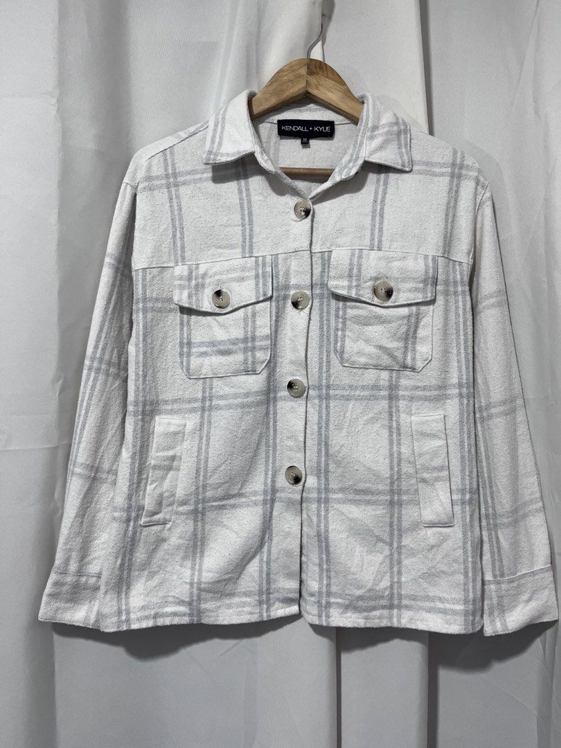 Kendall + Kylie White Grey Plaid Shacket Size M (Category: Coats, Jackets and Outerwear) located in Baguio. Submitted by miisthyshop.ph (Listing ID 1464847348, Image 1). Description: - Brand: Kendall + Kylie - Style: Plaid shirt jacket (shacket) - Color: White and grey - Size: Medium - Material: 60% cotton, 40% polyester blend - Features: Button-down front with tortoise-style buttons, 2 chest flap pockets, 2 side hand pockets, and long sleeves wi