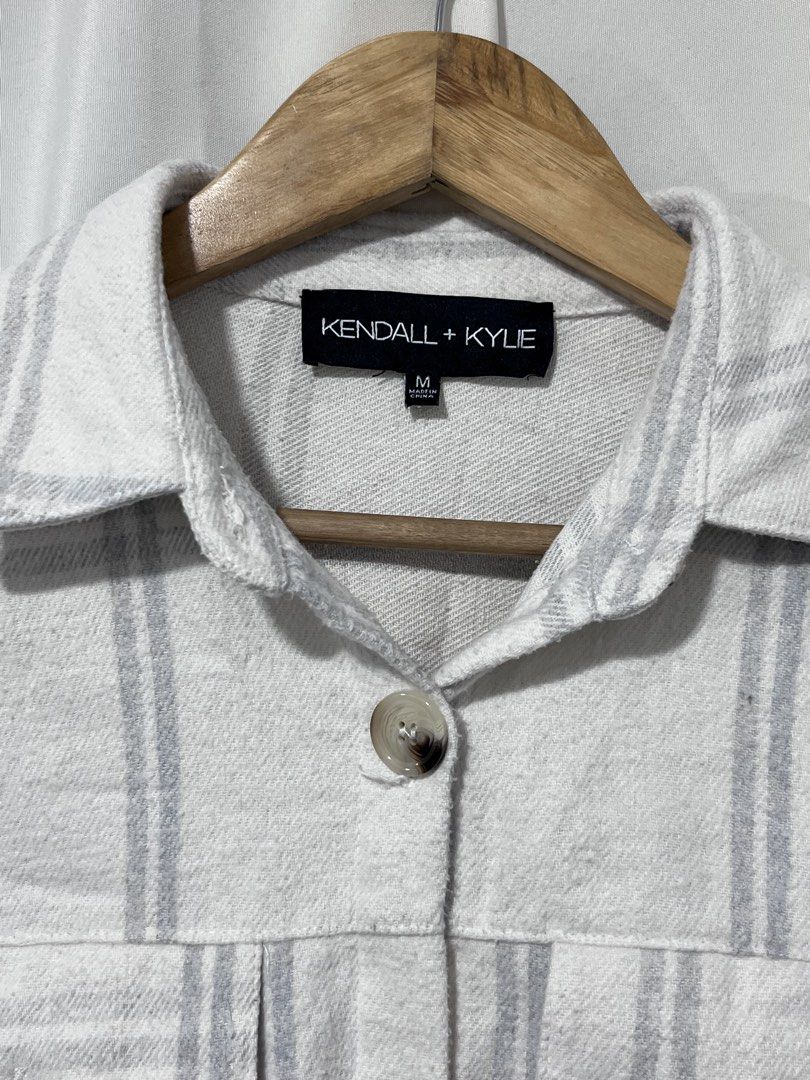 Kendall + Kylie White Grey Plaid Shacket Size M (Category: Coats, Jackets and Outerwear) located in Baguio. Submitted by miisthyshop.ph (Listing ID 1464847348, Image 3). Description: - Brand: Kendall + Kylie - Style: Plaid shirt jacket (shacket) - Color: White and grey - Size: Medium - Material: 60% cotton, 40% polyester blend - Features: Button-down front with tortoise-style buttons, 2 chest flap pockets, 2 side hand pockets, and long sleeves wi