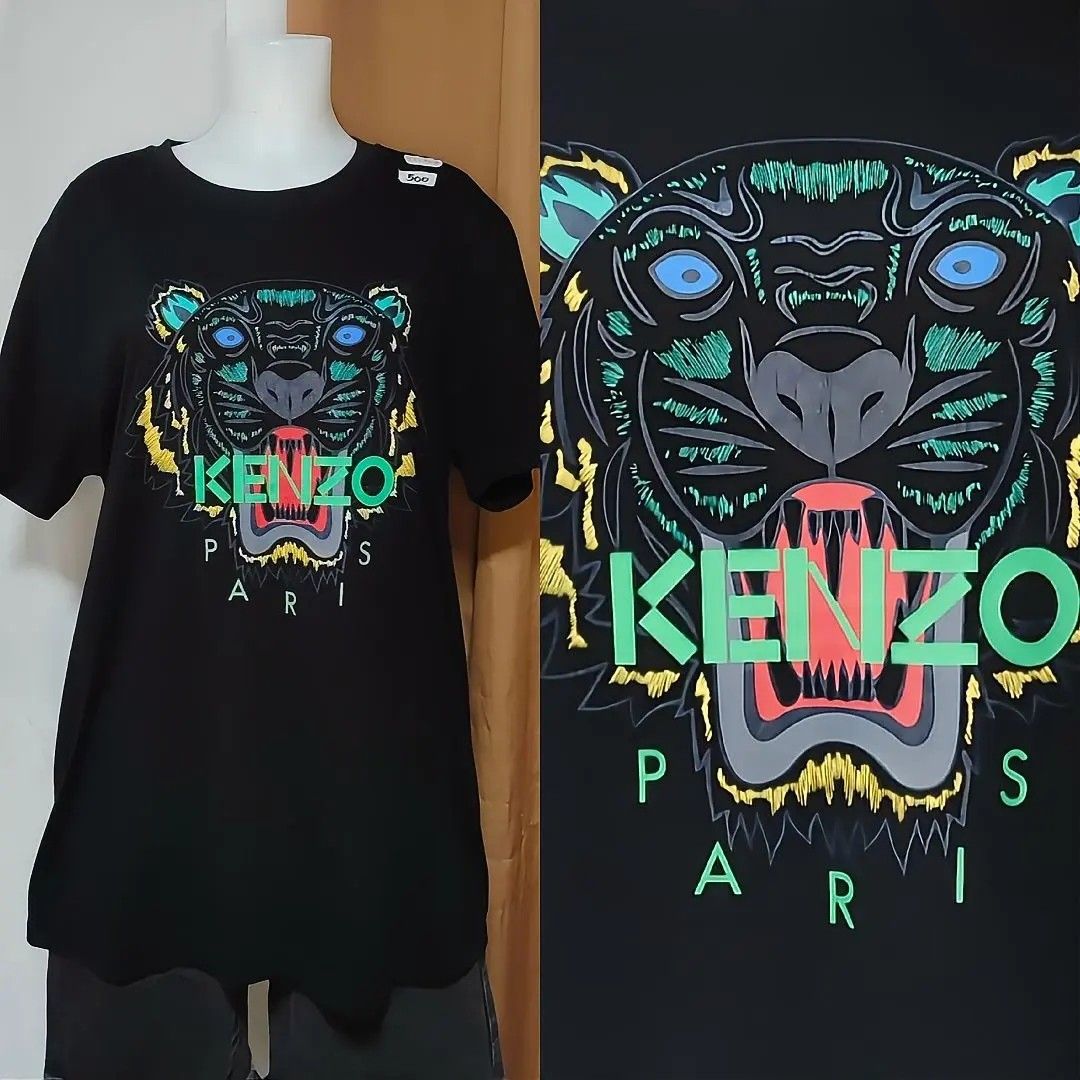 Kenzo Paris Neon Tiger Graphic (Category: Tshirts & Polo Shirts ) located in Caloocan City. Submitted by jmedalla1958179 (Listing ID 1464915172, Image 1). Description: Front: High-contrast neon green, blue, and yellow Kenzo Tiger head statement print with bold text branding. 📏Size & Dimension : Large- XL / 23x30.5 CR : 9/10, no issue print fully intact 📌 Authenticity of design/licensing is not claimed😎.