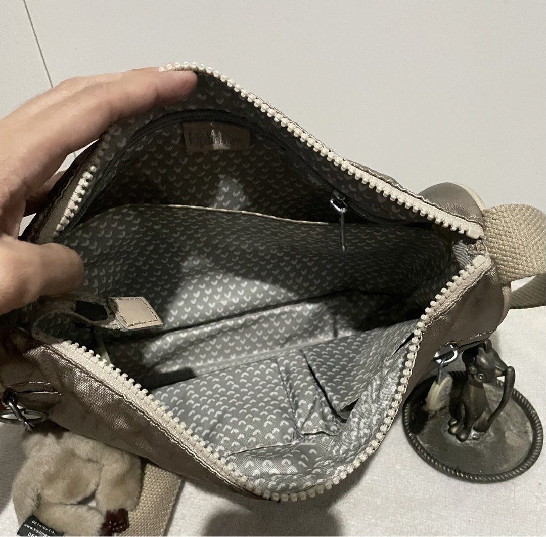 Kipling Bronze Small Sling Bag (Category: Cross-body Bags) located in Antipolo. Submitted by lilhermes (Listing ID 1464866218, Image 3). Description: Wide: 10 inches Height:7.5 inches No bakbak and tear part Fit folded umbrellla.