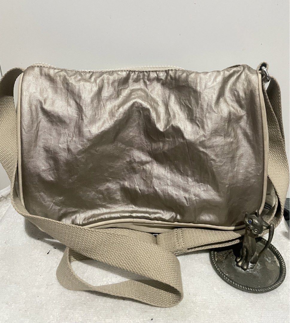 Kipling Bronze Small Sling Bag (Category: Cross-body Bags) located in Antipolo. Submitted by lilhermes (Listing ID 1464866218, Image 2). Description: Wide: 10 inches Height:7.5 inches No bakbak and tear part Fit folded umbrellla.