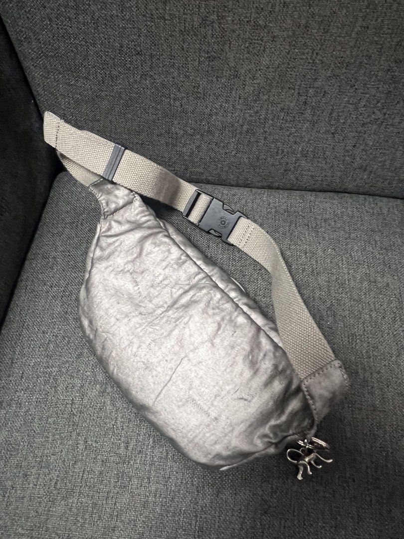 Kipling Metallic Silver Waist Bag Fanny Pack (Category: Belt bags, Clutches and Pouches) located in General Trias. Submitted by mybag2025 (Listing ID 1464906728, Image 3). Description: - Brand: Kipling - Material: Lightweight metallic silver crinkle nylon - Strap: Adjustable beige strap with quick-release buckle - Storage: Main zip compartment, front zip pocket, and interior zip pocket - Interior: Clean beige lining with Kipling woven cloth label