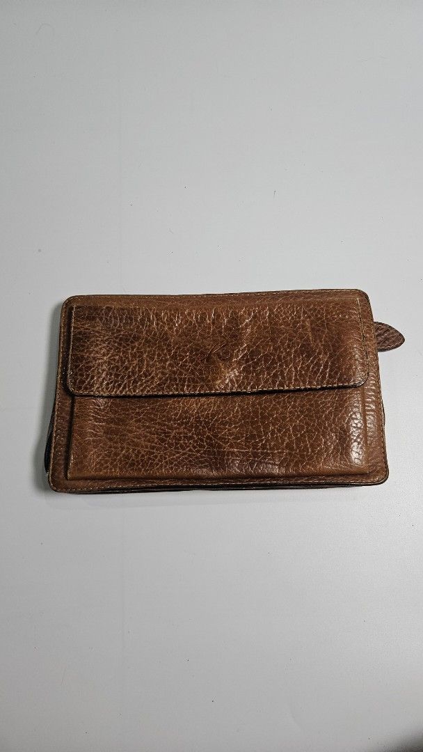 Kitamura Brown Leather Long clutch bag (Category: Wallets & Card holders) located in Alfonso. Submitted by jbcamet (Listing ID 1464908499, Image 1). Description: - Authentic Kitamura brown leather clutch bag - Genuine pebbled leather with stylish contrast stitching - Secure snap closure with interior brand tag logo - Exterior zippered pocket on the back for quick access - Multiple card slots, slip pockets, and main compartments for cash and daily