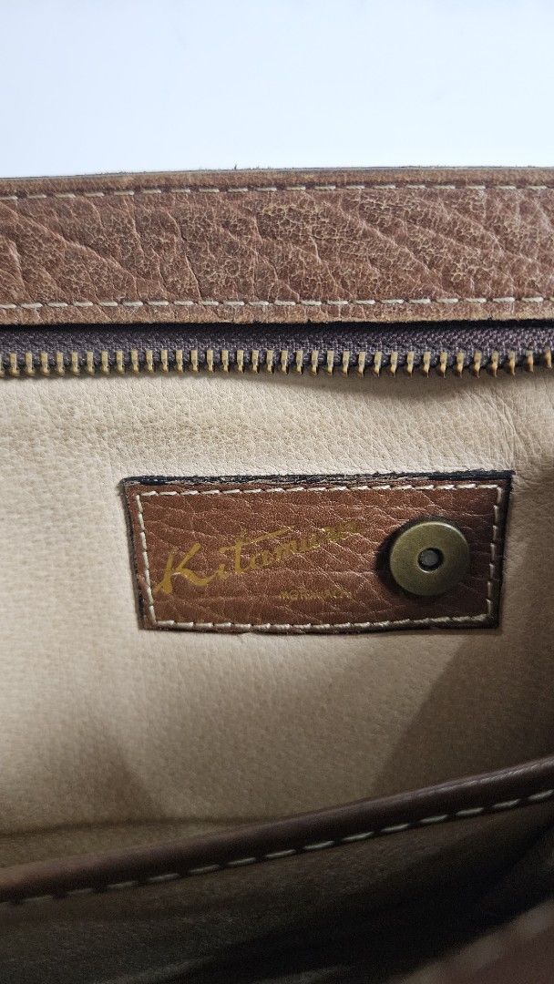Kitamura Brown Leather Long clutch bag (Category: Wallets & Card holders) located in Alfonso. Submitted by jbcamet (Listing ID 1464908499, Image 2). Description: - Authentic Kitamura brown leather clutch bag - Genuine pebbled leather with stylish contrast stitching - Secure snap closure with interior brand tag logo - Exterior zippered pocket on the back for quick access - Multiple card slots, slip pockets, and main compartments for cash and daily