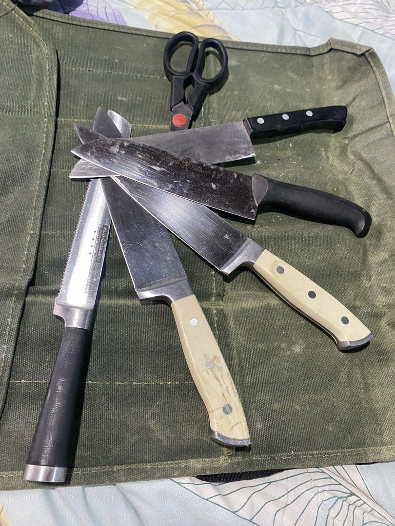 Kitchen Knife Set with EJJRY and ELO Germany Knives (Category: Knives & Chopping Boards) located in Caloocan City. Submitted by muscleman1328 (Listing ID 1464814973, Image 2). Description: - Bundle includes: EJJRY German steel chef knife, ELO Germany serrated utility knife, two cream-handled knives, black-handled chef knife, and Zwilling kitchen shears - Condition: Used set with visible surface scratches and wear on blades - Ideal as a starter se