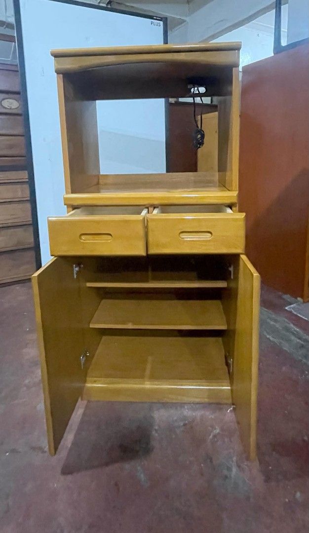 Kitchen Side Cabinet Oven Rack (Category: Shelves, Cabinets & Racks) located in Quezon City. Submitted by dannikkishoppe2 (Listing ID 1464792834, Image 3). Description: Kitchen Side Cabinet Oven Rack ‼️₱5800‼️ • Dimensions: 50" H x 23.5" L x 17" W (compact size for small spaces) • Top Shelf: Features a built-in power outlet with cord • Middle Section: Convenient pull-out shelf • Storage: 2 drawers and a lower double-door cabinet with internal she