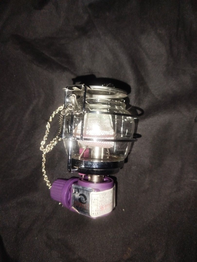 Kovea Gas Lantern with Hanging Chain (Category: Lighting) located in Manila. Submitted by jojo.welter (Listing ID 1464904554, Image 3). Description: - Brand: Kovea - Glass Globe: Genuine Schott Suprax (Made in Germany) - Features: Protective metal wire cage, stylish purple control knob, and twisted silver hanging chain - Compatibility: Screws directly onto standard camping gas canisters via brass valve - Excellent condition -Brand new never use.