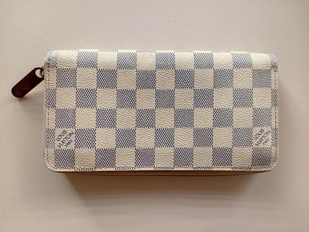 L 🩶V Damier Azur Zippy Wallet (Category: Luxury Bags & Wallets) located in Navotas City. Submitted by ms.soulana (Listing ID 1464801671, Image 2). Description: PreOwned Lightly Used WellUsed LV Damier Azur canvas zip-around wallet in white and blue checkerboard print - Gleaming gold-tone hardware with a branded zipper pull - Cream leather interior lining with multiple card slots and flat compartments - Secure zippered coin pocket for loose chang
