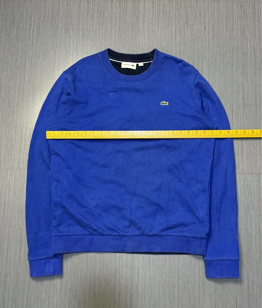 Lacoste Blue Sweatshirt (Category: Coats, Jackets and Outerwear) located in Caloocan City. Submitted by mzcollection_349 (Listing ID 1464885998, Image 3). Description: - Brand: Lacoste - Style: Crewneck sweatshirt - Color: Vibrant blue with dark contrast collar detail - Logo: Classic green embroidered crocodile on left chest - Details: Ribbed collar, cuffs, and hem; clean interior lining - Measurements: ~25" pit-to-pit, ~28" length from shoulder 