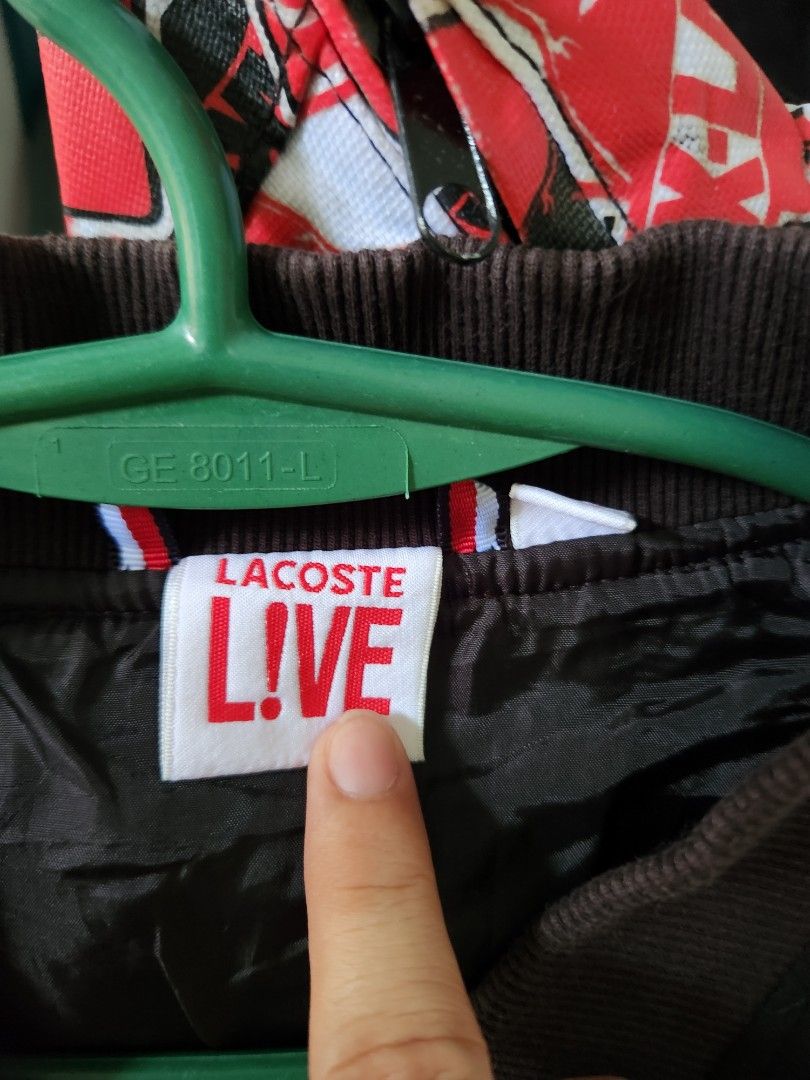 Lacoste Live Bomber Jacket (Category: Coats, Jackets and Outerwear) located in Paranaque City. Submitted by dwyanesteve (Listing ID 1464774028, Image 3). Description: - Brand: Lacoste Live - Style: Bomber Jacket - Color: Blacn - Size: US XL - Details: Zip-up front, branded snap-button pockets, inner zippered pocket, and ribbed collar, cuffs, and hem - Condition: Clean fabric and hardware, excellent overall condition fit to large 9/10 preowned RFS