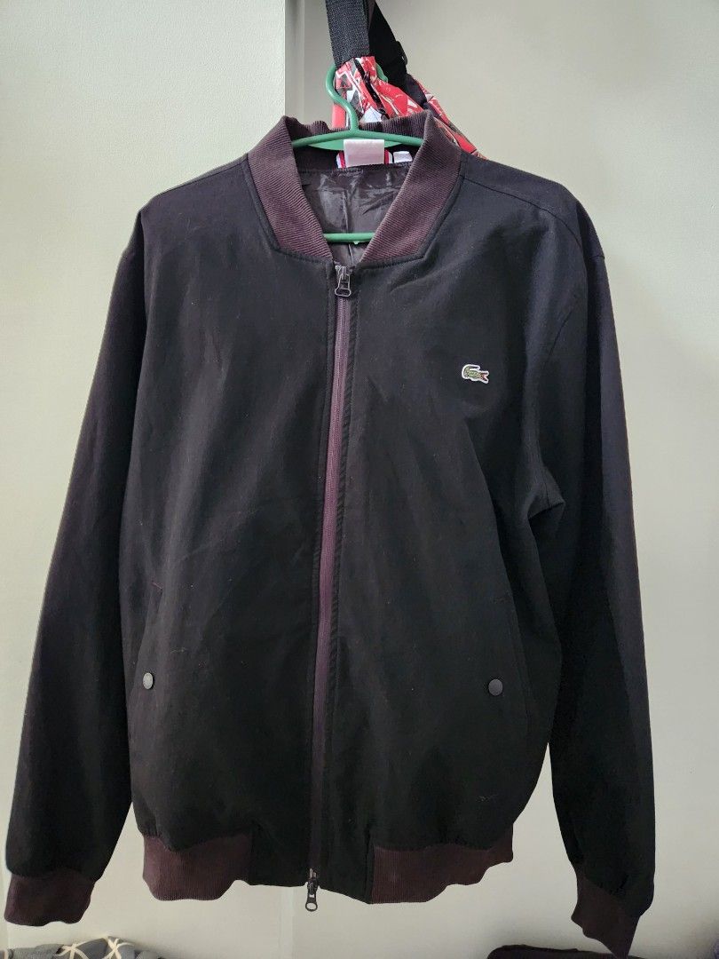 Lacoste Live Bomber Jacket (Category: Coats, Jackets and Outerwear) located in Paranaque City. Submitted by dwyanesteve (Listing ID 1464774028, Image 1). Description: - Brand: Lacoste Live - Style: Bomber Jacket - Color: Blacn - Size: US XL - Details: Zip-up front, branded snap-button pockets, inner zippered pocket, and ribbed collar, cuffs, and hem - Condition: Clean fabric and hardware, excellent overall condition fit to large 9/10 preowned RFS