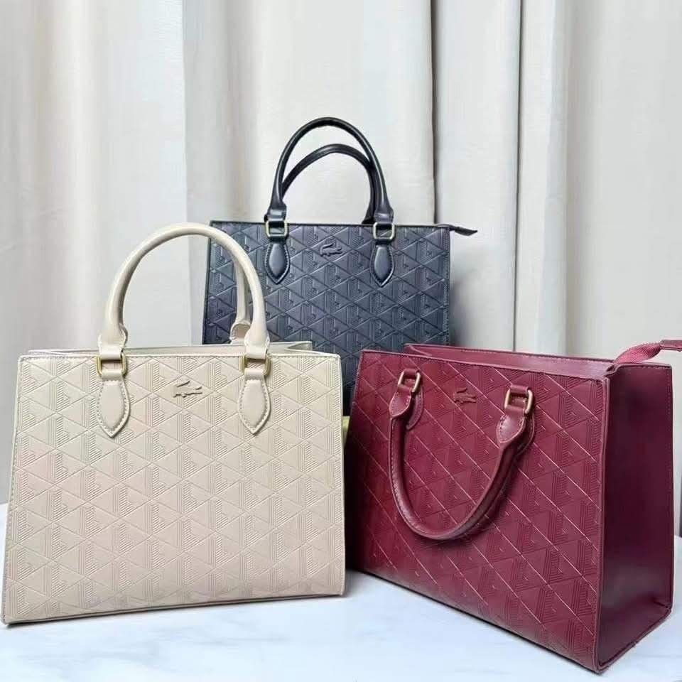 Lacoste Maheki Structured Tote Bag. Original (Category: Tote Bags) located in Mandaluyong City. Submitted by apparel_jenjo (Listing ID 1464896929, Image 1). Description: Description Line: Maheki Line, celebrating the iconic Lacoste monogram. Material: Crafted from calf leather featuring a full de-bossed geometric monogram pattern. Hardware & Accents: Finished with gold-tone metal hardware connectors and a sleek tone-on-tone Lacoste crocodile logo