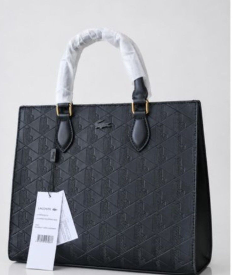 Lacoste Maheki Structured Tote Bag. Original (Category: Tote Bags) located in Mandaluyong City. Submitted by apparel_jenjo (Listing ID 1464896929, Image 2). Description: Description Line: Maheki Line, celebrating the iconic Lacoste monogram. Material: Crafted from calf leather featuring a full de-bossed geometric monogram pattern. Hardware & Accents: Finished with gold-tone metal hardware connectors and a sleek tone-on-tone Lacoste crocodile logo