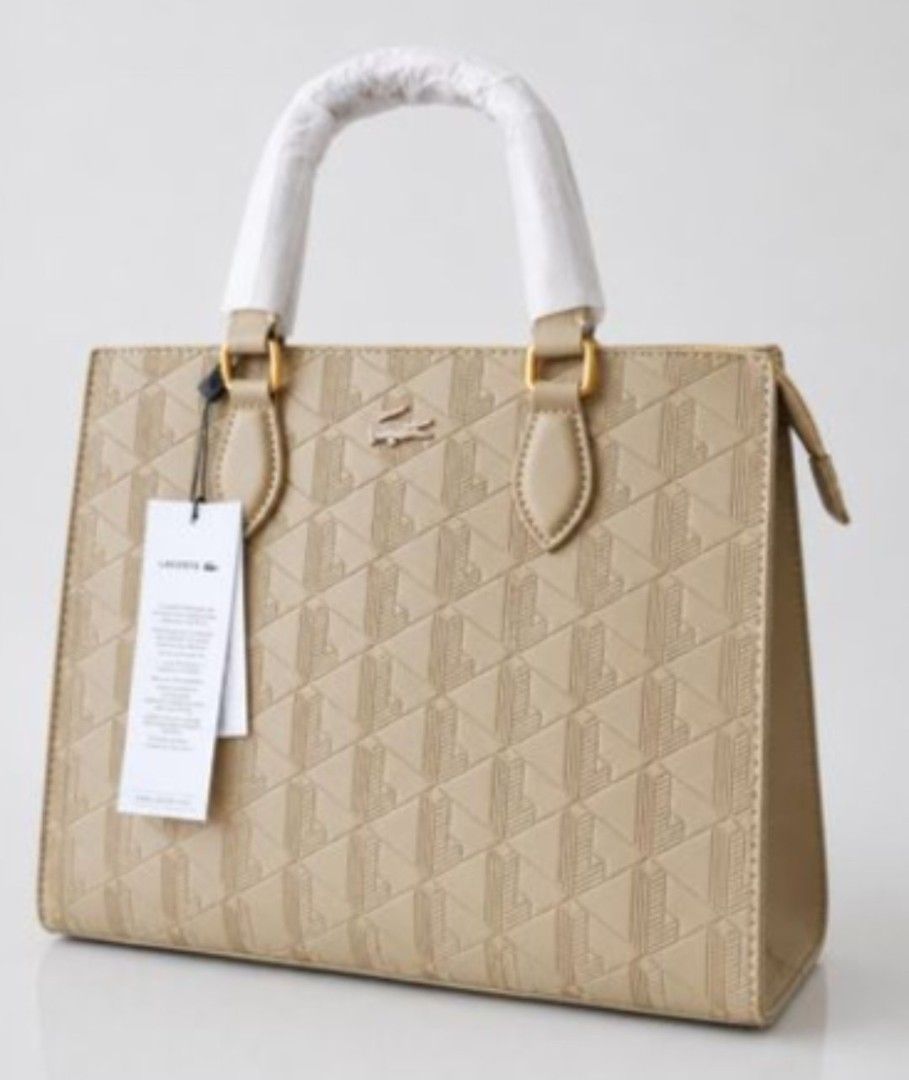 Lacoste Maheki Structured Tote Bag. Original (Category: Tote Bags) located in Mandaluyong City. Submitted by apparel_jenjo (Listing ID 1464896929, Image 3). Description: Description Line: Maheki Line, celebrating the iconic Lacoste monogram. Material: Crafted from calf leather featuring a full de-bossed geometric monogram pattern. Hardware & Accents: Finished with gold-tone metal hardware connectors and a sleek tone-on-tone Lacoste crocodile logo