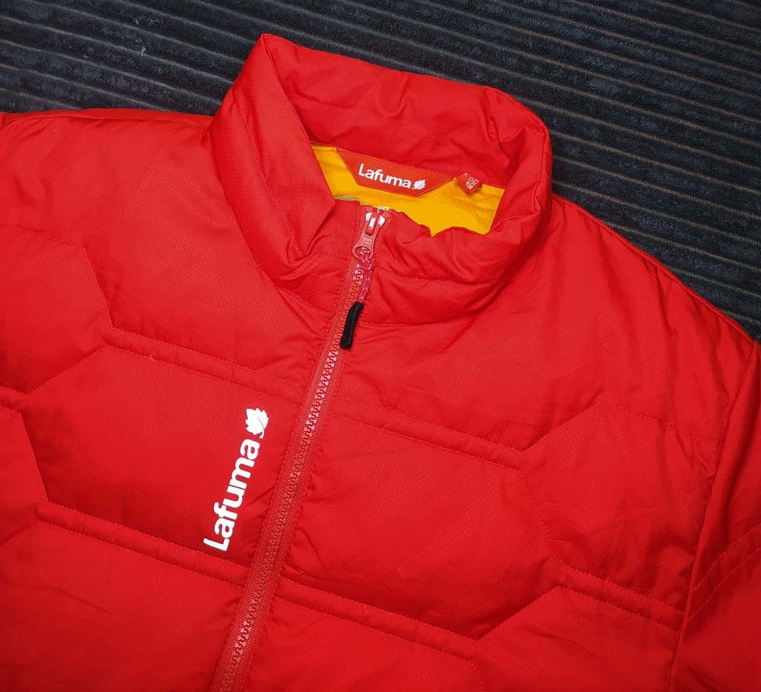 Lafuma 550 Fill Power Red Puffer Jacket (Category: Coats, Jackets and Outerwear) located in Manila. Submitted by norathrifted (Listing ID 1464803829, Image 3). Description: - Brand/Model: Lafuma Puffer Jacket - Color: Vibrant red with bright yellow inner lining - Insulation: 550 fill power down (super warm and lightweight) - Size: M / 170 / 92A - Features: Full zip front, high collar, zippered side pockets, white chest branding - Condition: Excel