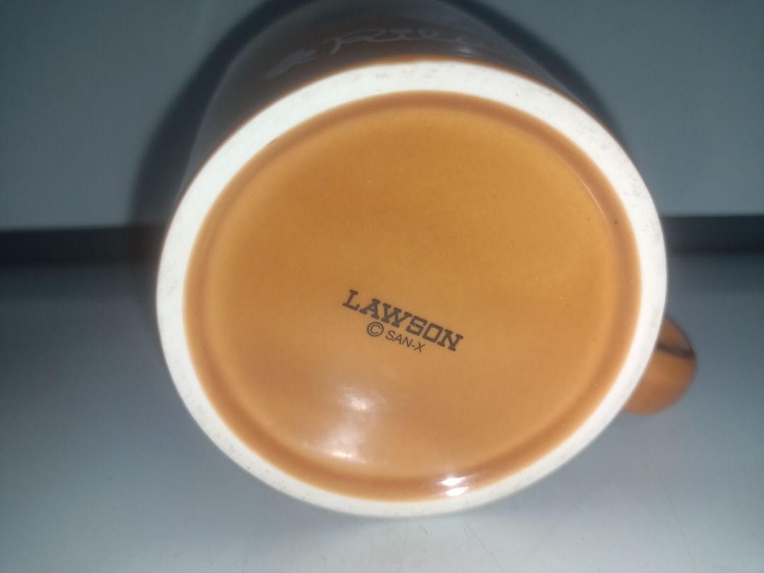 Lawson Rilakkuma Ceramic Mug Brown San-X (Category: Coffee & Tea Tableware) located in Munoz. Submitted by larryc1212 (Listing ID 1464893737, Image 3). Description: - Authentic San-X Rilakkuma ceramic mug from Lawson - Color: Brown with smooth glaze finish and character face print - Size: Approximately 5 inches wide x 3.25 inches tall - Features official Lawson and San-X stamps on the bottom - Sturdy side handle for a comfortable grip - Clean int