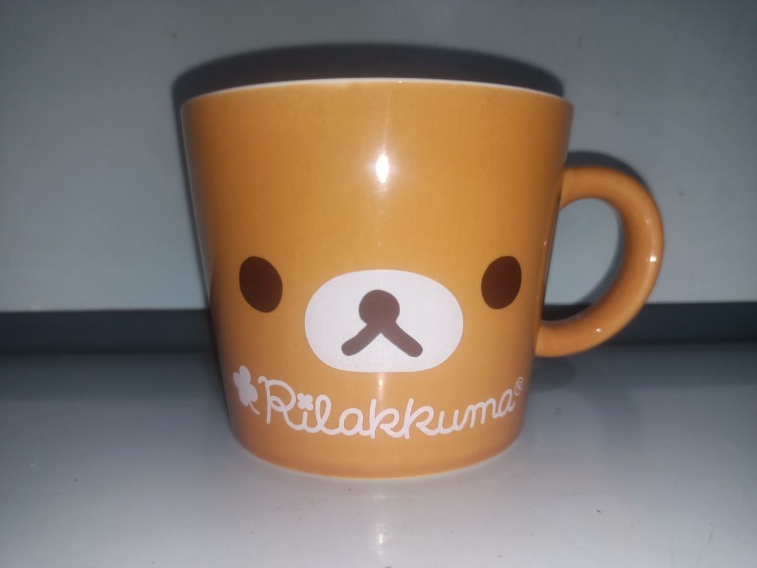 Lawson Rilakkuma Ceramic Mug Brown San-X (Category: Coffee & Tea Tableware) located in Munoz. Submitted by larryc1212 (Listing ID 1464893737, Image 2). Description: - Authentic San-X Rilakkuma ceramic mug from Lawson - Color: Brown with smooth glaze finish and character face print - Size: Approximately 5 inches wide x 3.25 inches tall - Features official Lawson and San-X stamps on the bottom - Sturdy side handle for a comfortable grip - Clean int