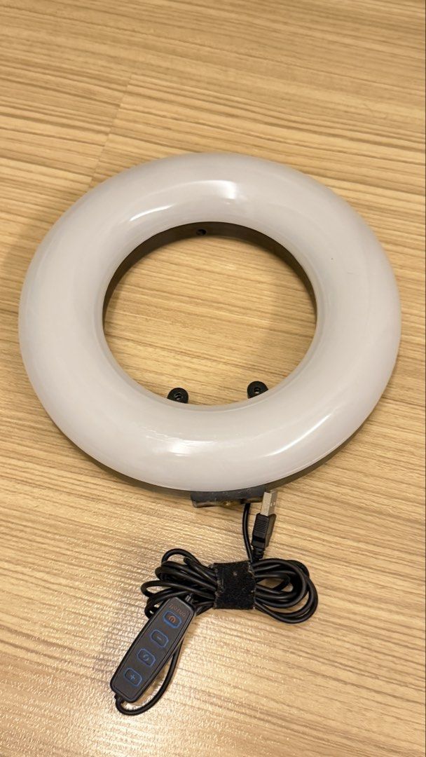 LED Ring Light with USB Cable and Inline Controller (Category: Lighting & Studio Equipment) located in Kuala Lumpur. Submitted by cath91 (Listing ID 1464911721, Image 1). Description: Round LED ring light with attached USB power cable. Includes inline control pad with four buttons for power, brightness, and mode adjustment. Cord is wrapped with a velcro tie. Black casing with white diffusing cover..