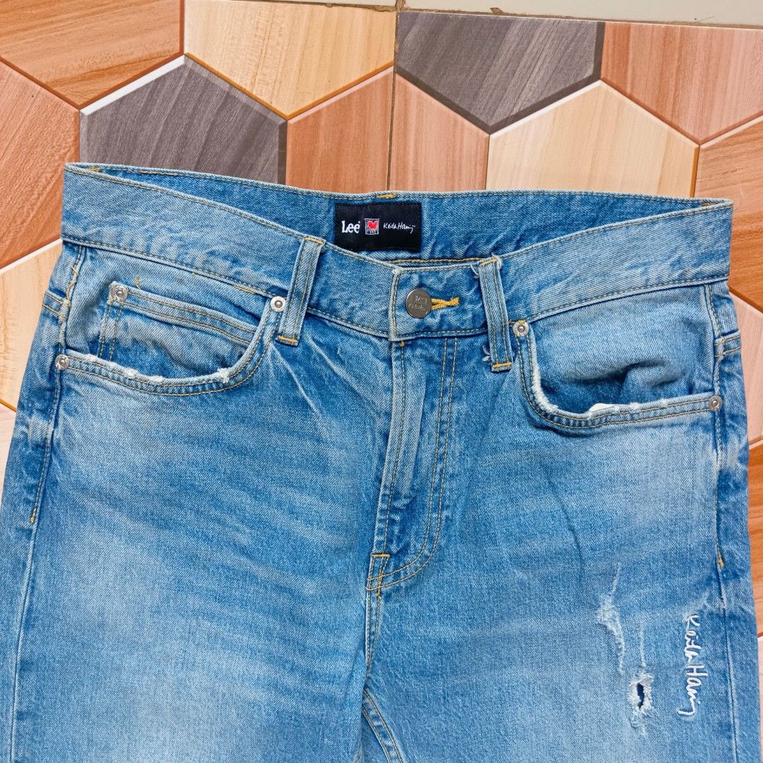 Lee x Keith Haring Light Wash Denim Jeans (Category: Jeans) located in Manila. Submitted by caps08 (Listing ID 1464882667, Image 2). Description: - Brand: Lee x Keith Haring collaboration - Color: Light wash blue - Fit: Mid-rise, classic five-pocket styling with button closure and belt loops - Details: Distressing on front and back pockets - Special Features: Iconic barking dog graphic embroidered on the back leg and signature script embroidery o