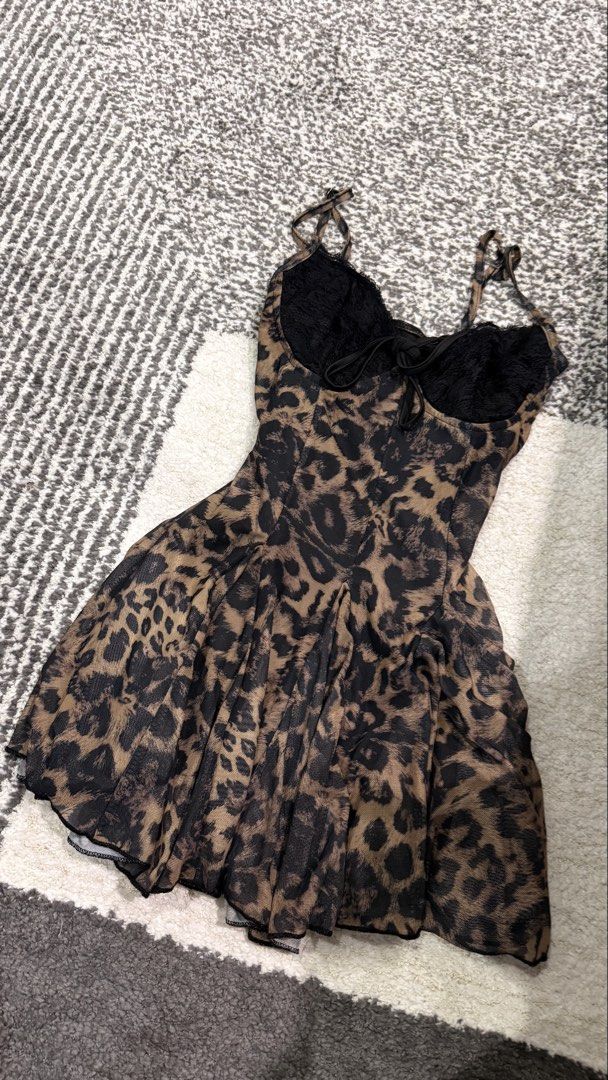 Leopard Print Mesh Corset Mini Dress with Black Lace (Category: Dresses) located in Cavite. Submitted by chizilvs (Listing ID 1464931621, Image 1). Description: Chic leopard print mesh dress featuring black lace cups, adjustable straps, and a cute front tie. Made with soft sheer fabric and a flared pleated skirt—perfect for your next night out!.