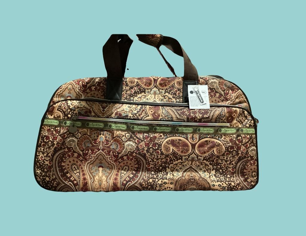 Lesportsac Rolling Duffel Bag (Category: Luggage) located in Paranaque City. Submitted by calm_youngstore7 (Listing ID 1464931085, Image 1). Description: Lesportsac Rolling Duffel Bag Satchel Travel in style with this Luggage Carry On Travel Suitcase. Perfect size for a weekend trip or as a carry on luggage when traveling. Cabin size fit. *Roomy open storage *Easy transition from handheld luggage to to a rolling duffel bag • with hidden retractab