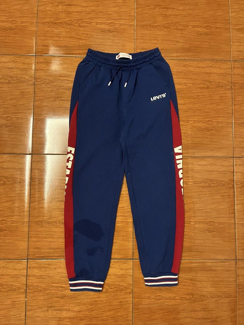 Levi's Knit Jogger Pants Blue Red Size M (Category: Joggers) located in Calasiao. Submitted by cristinabarongan5 (Listing ID 1464833607, Image 1). Description: - Brand: Levi's - Style: Knit jogger sweatpants with red side panels and white text branding - Size: M (150/63) - Color: Blue with red and white accents - Material: Comfortable cotton-polyester blend - Features: Adjustable drawstring waistband with branded aglets, ribbed ankle cuffs, and b