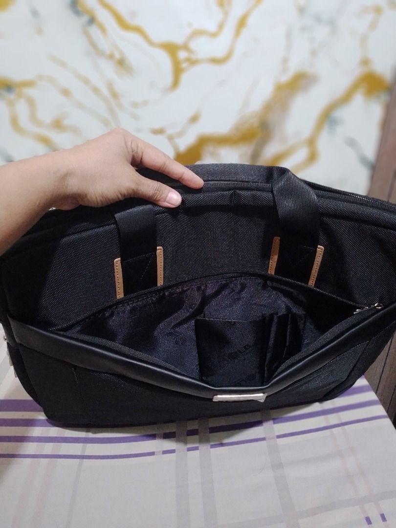 LG Laptop Bag Briefcase Black (Category: Laptop Bags & Sleeves) located in Imus. Submitted by bestfinds_yeth0724 (Listing ID 1464954853, Image 3). Description: - Color: Classic black with stylish LG branded lining - Exterior: Dual carry handles and a convenient outer zipped pocket - Interior: Padded laptop compartment with strap closure plus organizational slots - Branding: Premium metal logo plate on the front - Authenticity: Product code NB15-2